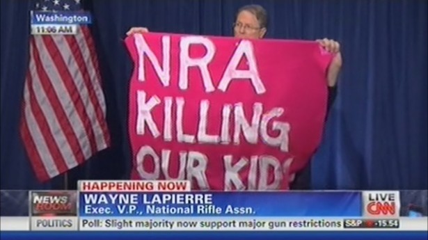 The NRA has been at the center of the gun control debate. Here a protester from Code Pink interrupts a press conference following the Sandy Hook shooting,  photo screenshot CNN coverage