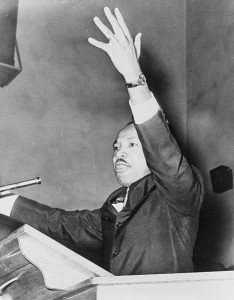 1962 New York World-Telegram and the Sun staff photographer Martin Luther King, Jr., half-length portrait, facing left, with left arm raised, at freedom rally, Washington Temple Church / World Telegram & Sun photo by O. Fernandez.