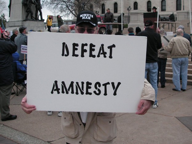 man with defeat amnesty immigration sign