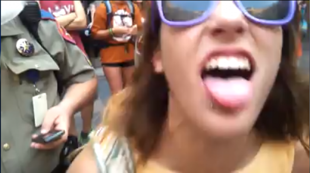 A pro-abortion supporter mocks Christians singing 'Amazing Grace' in the Texas State Capitol building as her colleagues chant 'Hail Satan'. screenshot acahnman.blogspot.com