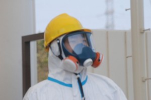 The dangers of the Fukushima nuclear plant continue photo of worker in 2011, S. Herman via wikimedia commons