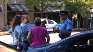 police officer meeting with group attempting to feed homeless