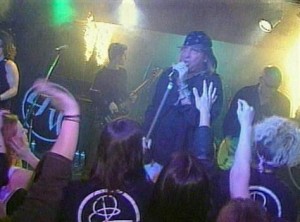 In this image from video shot by TV station WPRI, a musician notices fire spreading behind the band Great White onstage at The Station nightclub Feb. 20, 2003 in West Warwick, Rhode Island. 