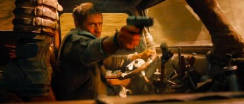 Tom Hardy Mad Max Fury Road takes aim with gun