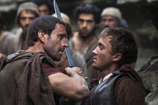 Clavius (Joseph Fiennes, left) warns Lucius (Tom Felton) to let them all pass, after he discovers him leading the apostles away from the Roman soldiers in TriStar Pictures' RISEN.