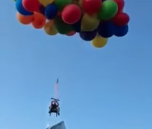 Dan Boria high over Calgary in his "balloon chair"  photo/ screenshot YouTube