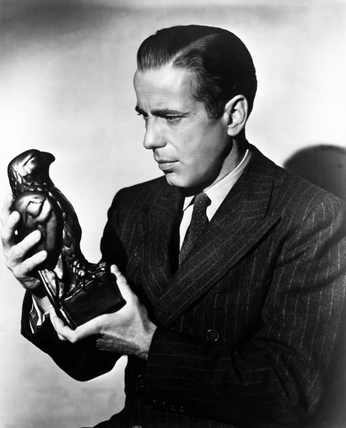 Humphrey Bogart as Sam Spade, holding the Maltese Falcon.