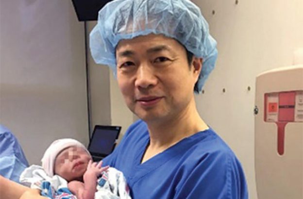 Dr. John Zhang with the first baby born with three different DNAs