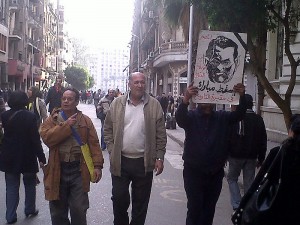 Men with a sign depicting Hosni Mubarak as a monster. January 2011 Photo/Mona via wikimedia commons