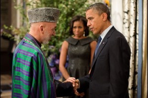 President Barack Obama talks with President Hamid Karzai of Afghanistan before the United Nations General Assembly reception at the Waldorf Astoria Hotel in New York, N.Y., Sept. 24, 2012. First Lady Michelle Obama is pictured in the background. (Official White House Photo by Pete Souza)