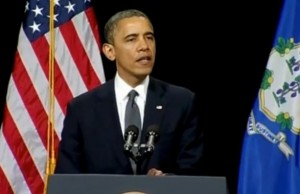 President Obama delivering a speech at the Newtown High School, telling the community "You are not alone."  photo screenshot of Reuters video