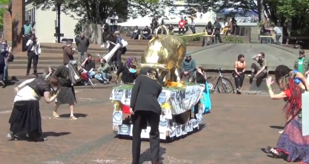 Occupy dancers bow golden calf