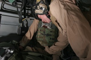  As they fly towards a hospital in Iraq, Lt. j. g. Paul Greer, a chaplain with 2nd Marine Aircraft Wing, prays for a wounded Soldier during an urgent casualty evacuation mission, Oct. 27. The Soldiers condition improved as Greer prayed over him. photo/ 2004 USMC 