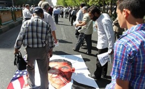 Protests in Iran involve spitting on photos of President Obama
