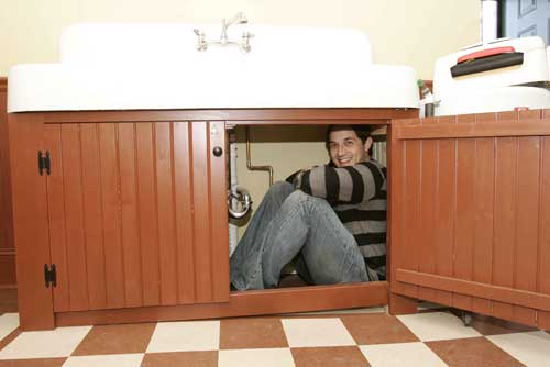 Ian Petrella, reliving his days as Randy under the sink - A Christmas Story House photo