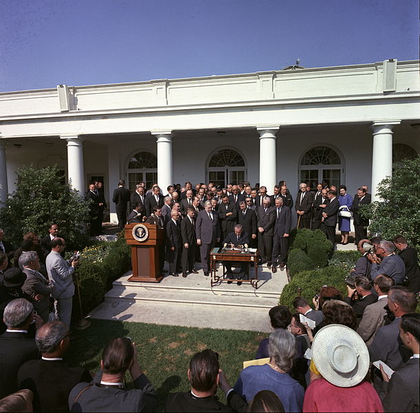 The day President Johnson signed the Economic Opportunity Act of 1964