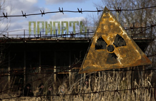 A radioactive sign hangs on barbed wire outside a café in Pripyat. photo VOA Photo / D. Markosian