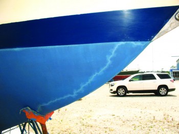 The jagged line in this sailboat’s hull paint is a "lightning track" that shows how the electrical charge passed from the bobstay to the jackstand to reach the ground. Image/BoatUS
