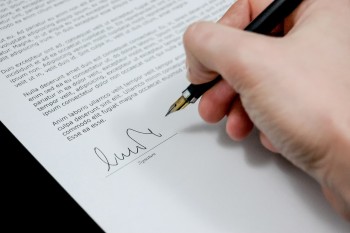 hand writing signing a document photo/ Michael Jarmoluk via pixabay.com