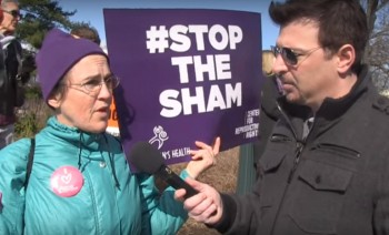 Pro choice abortion supporter at rally with Stop the Sham sign